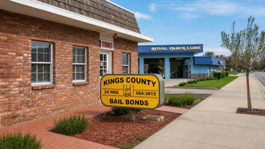 The Kings County Bail Bonds office in Hanford, a brick building set back behind a low planted bed